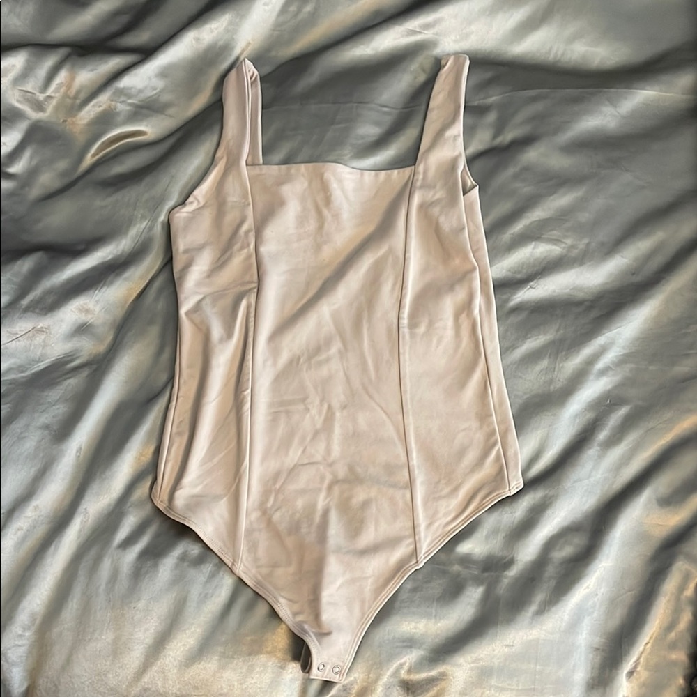Cream Bodysuit with High-Cut Leg and Sleeveless Design